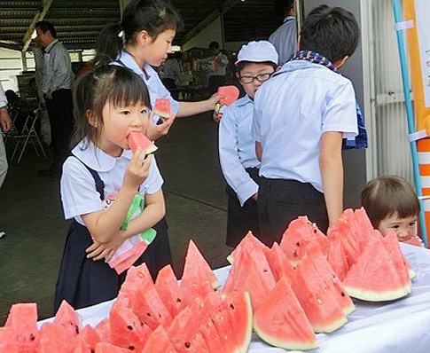 萩相島スイカを食べる子どもたちの写真